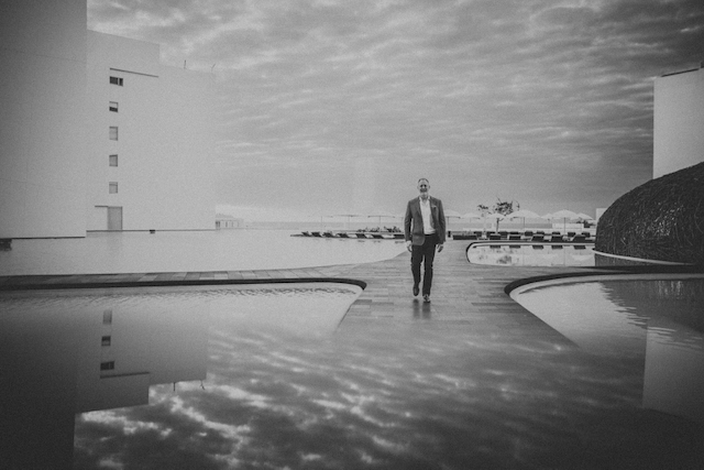 Jeffrey Van Dyk standing on coastal rocks, looking out at the ocean