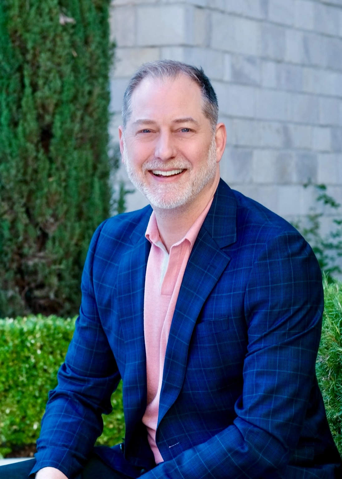 Jeffrey Van Dyk headshot, smiling in a navy plaid blazer